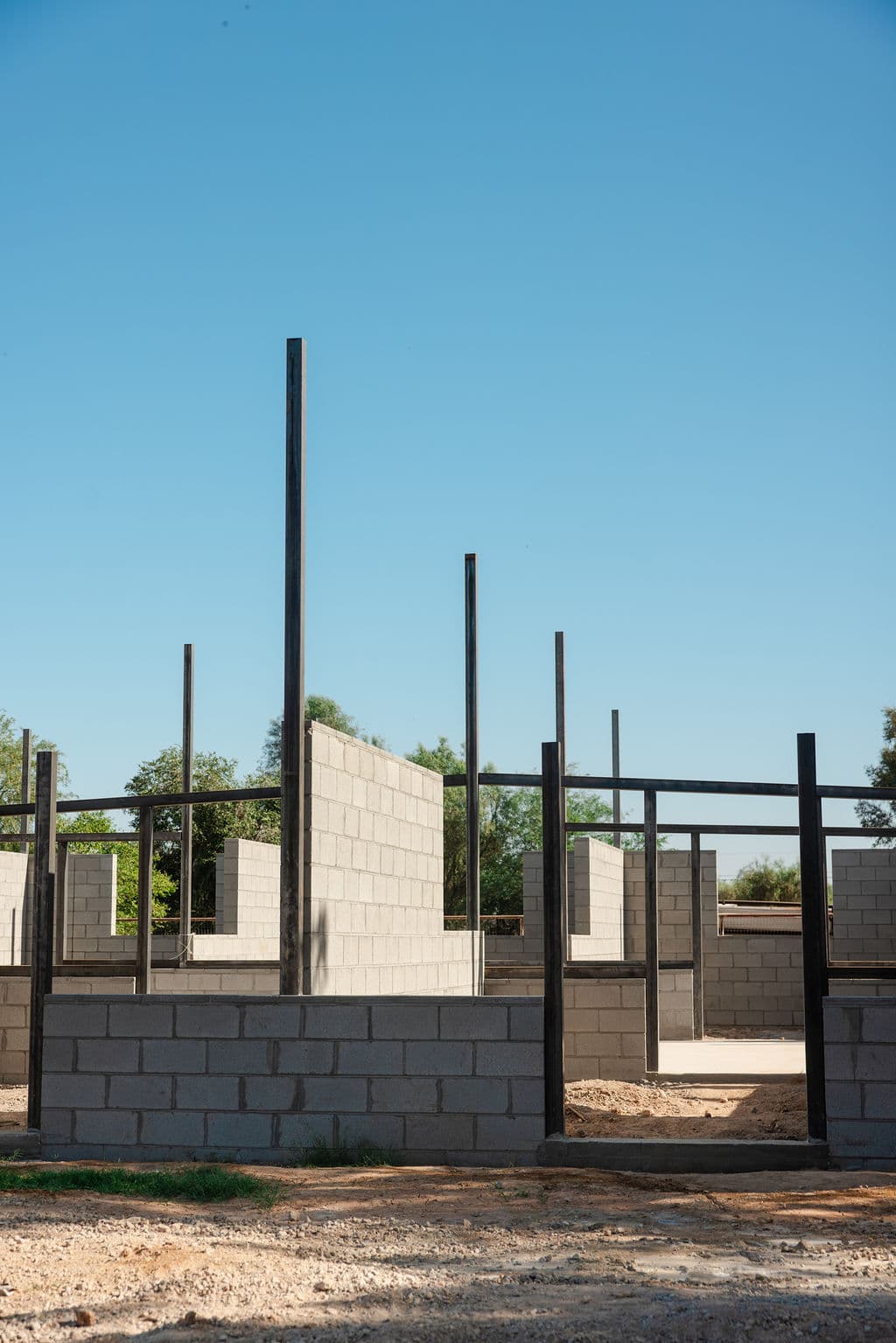 Block walls and steel posts of the new barn going up